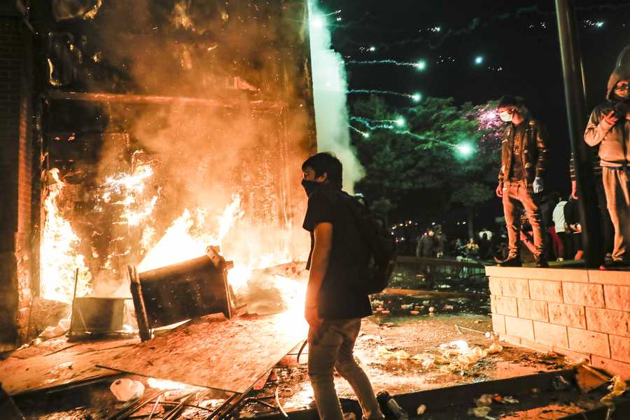 Protestors demonstrate outside of a burning Minneapolis 3rd Police Precinct, Thursday, May 28, 2020, in Minneapolis. Protestors demonstrate outside of a burning Minneapolis 3rd Police Precinct, Thursday, May 28, 2020, in Minneapolis.