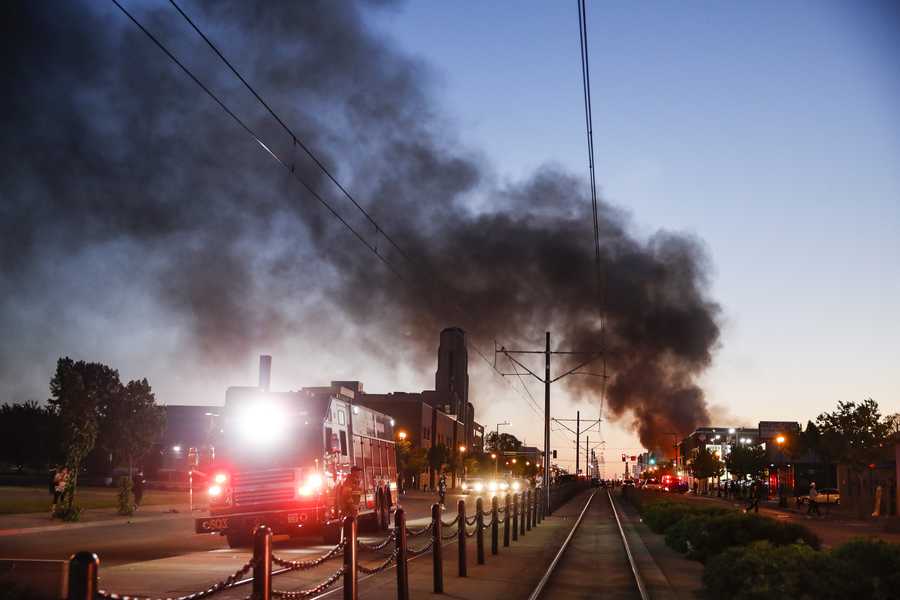 A building burns along University Avenue during a protest, Thursday, May 28, 2020, in St. Paul, Minn.