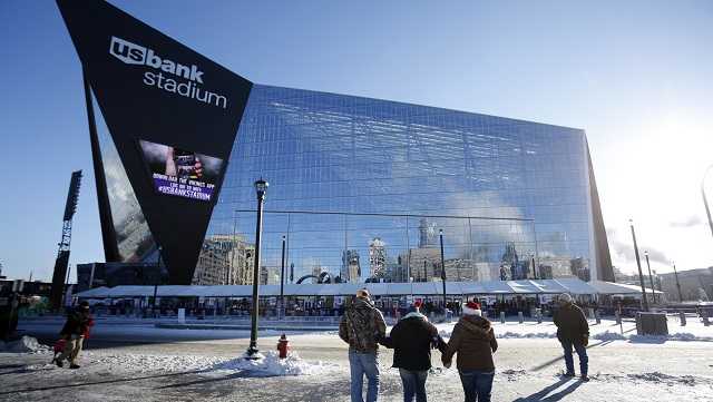 In this Dec. 18, 2016, file photo, fans bundled up for the cold weather head for U.S. Bank Stadium before the start of an NFL football game.