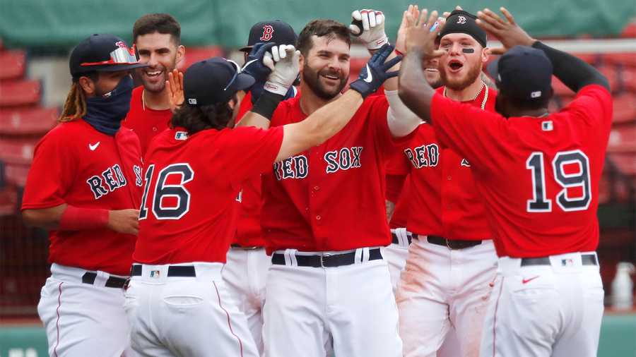 Boston Red Sox's Mitch Moreland, center, celebrates his two-run, walk-off home run during the ninth inning of a baseball game against the Toronto Blue Jays, Sunday, Aug. 9, 2020, in Boston. (AP Photo/Michael Dwyer)