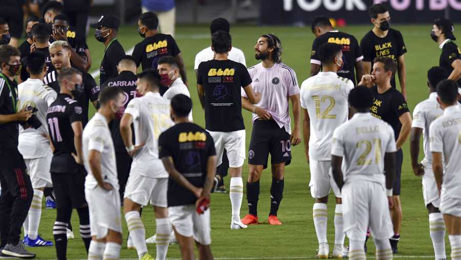 Players from Inter Miami and Atlanta United gather on the field before a scheduled MLS soccer match, Wednesday, Aug. 26, 2020, in Fort Lauderdale, Fla. Major League Soccer players boycotted five games Wednesday night in a collective statement against racial injustice. The players' action comes after NBA playoff games were called off in a protest over the shooting of Jacob Blake in Wisconsin on Sunday night.
