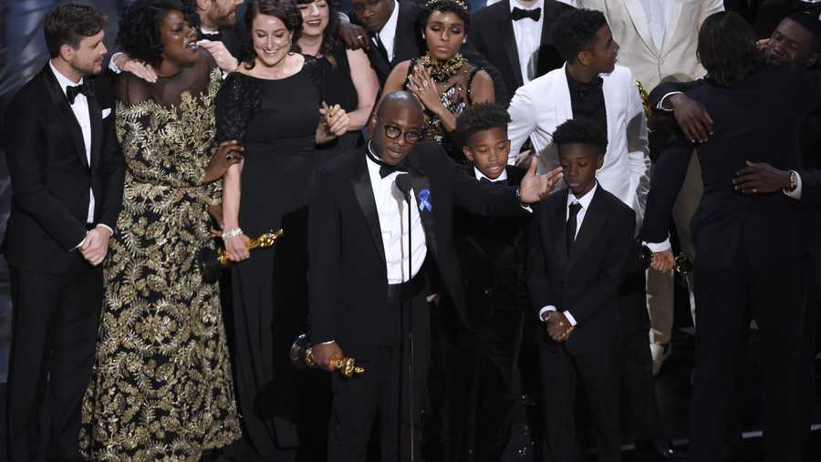 Barry Jenkins, foreground center, and the cast accept the award for best picture for "Moonlight" at the Oscars on Sunday, Feb. 26, 2017, at the Dolby Theatre in Los Angeles. 