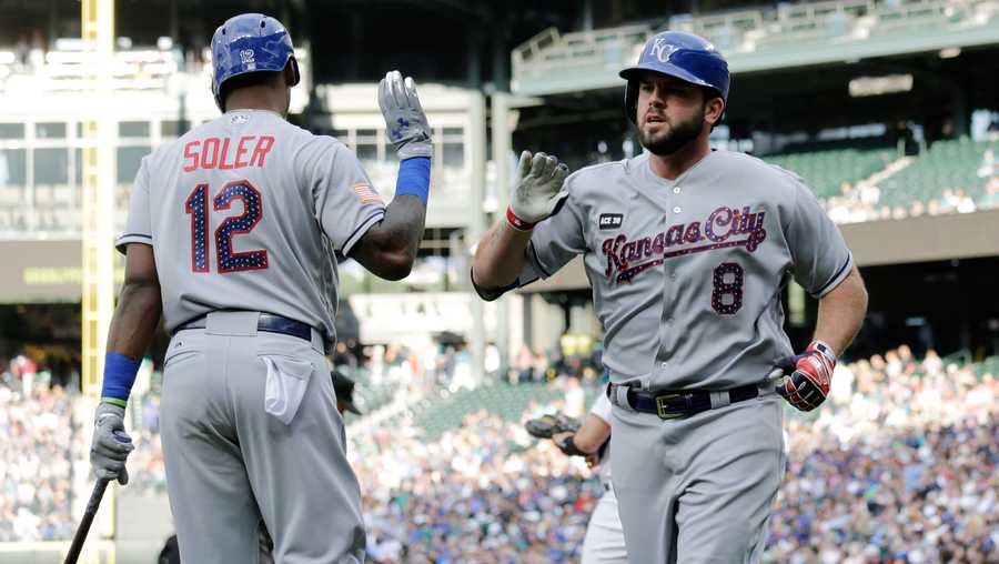 Kansas City Royals' Mike Moustakas, right, is greeted by Jorge Soler at home plate after hitting a solo home run against the Seattle Mariners during a baseball game, Monday, July 3, 2017, in Seattle. (AP Photo/John Froschauer)