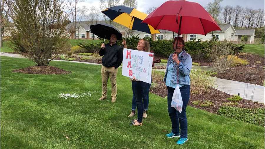 rebecca roy and her family serenading their grandma outside her living facility on sunday