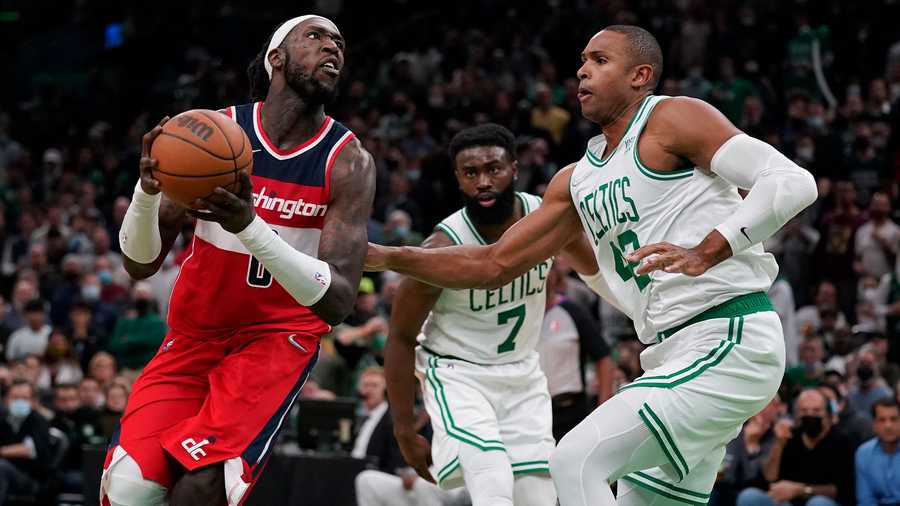 Washington Wizards center Montrezl Harrell, left, drives to the basket against Boston Celtics center Al Horford (42) during the second half of an NBA basketball game, Wednesday, Oct. 27, 2021, in Boston. (AP Photo)