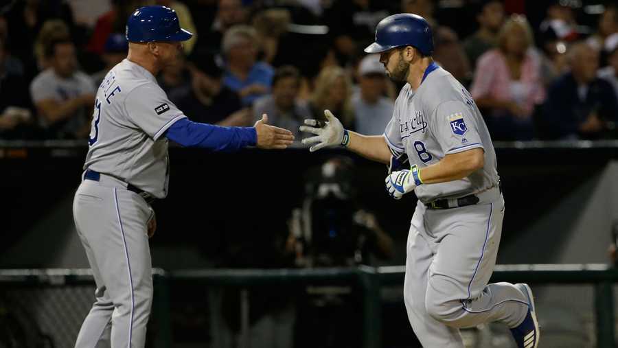 Kansas City Royals' Mike Moustakas, right, celebrates with third base coach Mike Jirschele after hitting a solo home run against the Chicago White Sox during the fourth inning of a baseball game Friday, Aug. 11, 2017, in Chicago. (AP Photo/Nam Y. Huh)