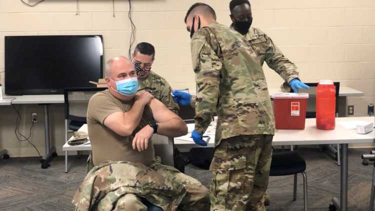 A member of the Mississippi National Guard receives the COVID-19 vaccine.