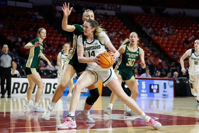 Michigan State forward Grace Vanslooten (14) drives to the basket past Colorado State forward Lexi Deden (6) during the first half in the first round of the NCAA college basketball tournament Friday, March 20, 2026, Norman, Okla.