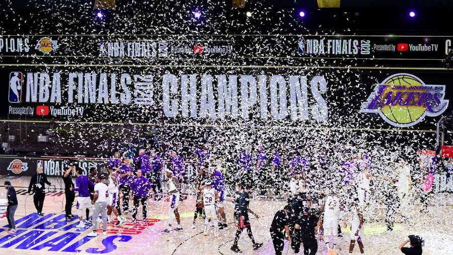 The Los Angeles Lakers celebrate with the trophy after winning the 2020 NBA Championship Final over the Miami Heat in Game Six of the 2020 NBA Finals at AdventHealth Arena at the ESPN Wide World Of Sports Complex on Oct. 11, 2020 in Lake Buena Vista, Florida. (Photo by Douglas P. DeFelice/Getty Images)