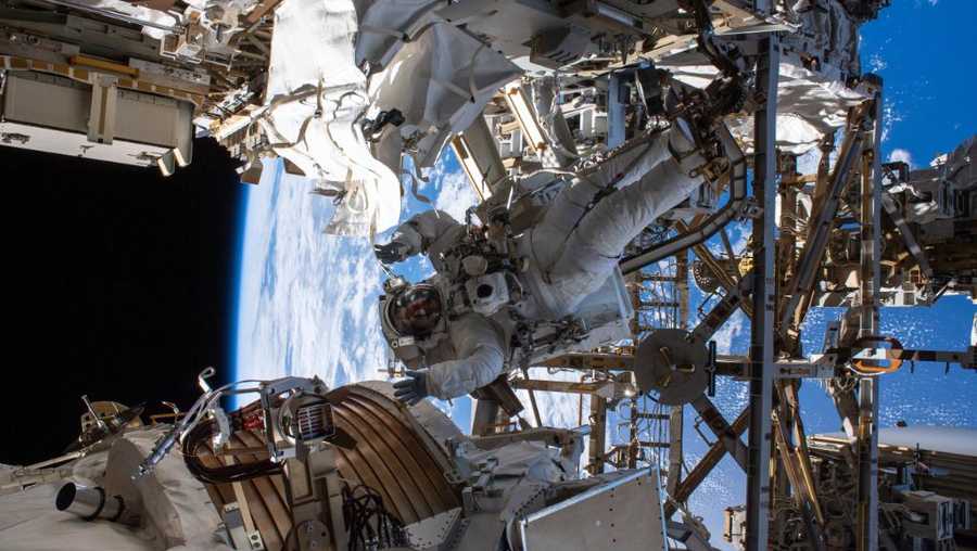 Spacewalking astronauts have cut into a cosmic ray detector in order to fix it.