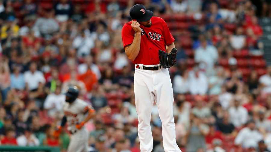 Boston Red Sox's Nathan Eovaldi stands on the mound after giving up a solo home run to Jose Altuve, left, during the third inning of a baseball game, Wednesday, June 9, 2021, in Boston. (AP Photo)