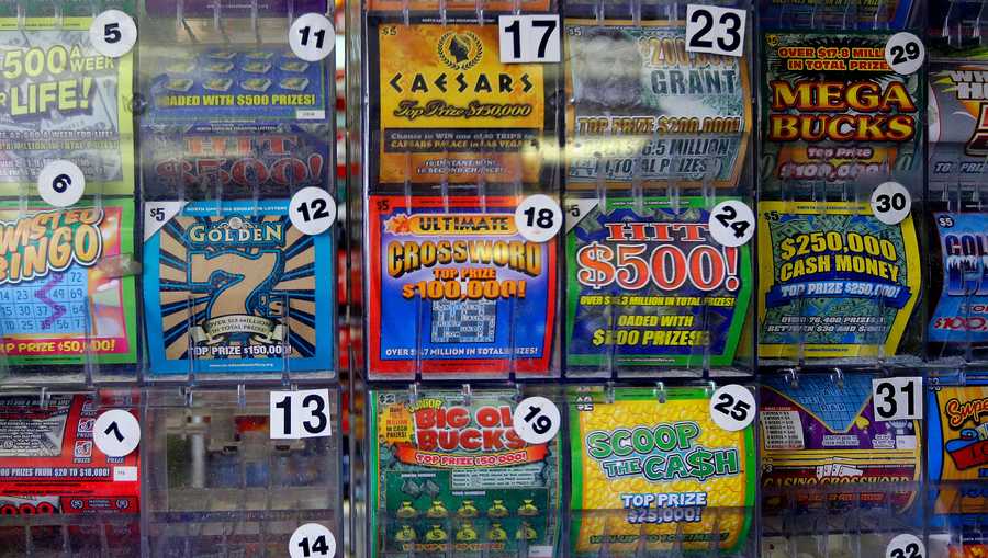 In this Thursday, July 17, 2014 photo, scratch-off lottery tickets for sale are on display at Eagles Express in Knightdale, N.C. Kevin Clark, of Candler, North Carolina, played a hunch and went on a journey to find the last top prize of the $5,000,000 Mega Cash scratch-off game.