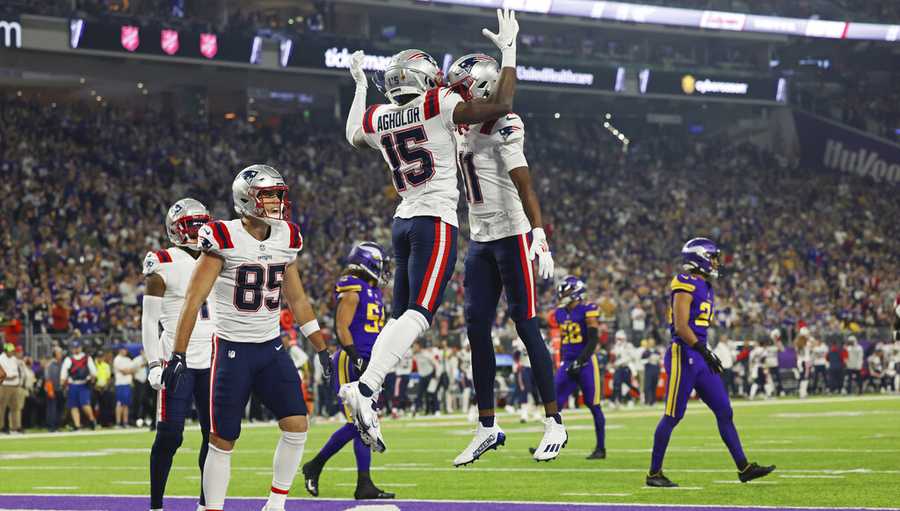 New England Patriots wide receivers Nelson Agholor (15) and Tyquan Thornton (11) celebrate after Agholor scored a touchdown against the Minnesota Vikings during the first half of an NFL football game Thursday, Nov. 24, 2022 in Minneapolis. (AP Photo/Stacy Bengs)
