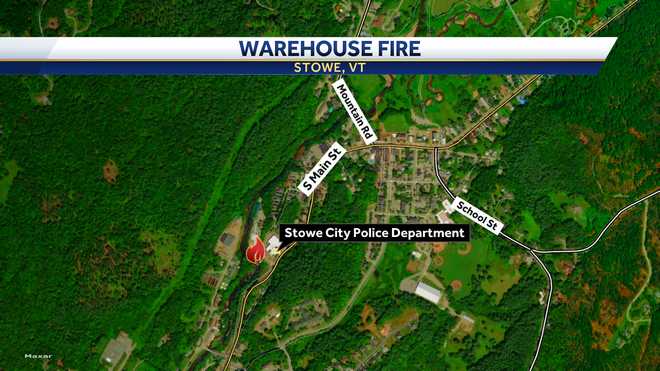 Crews are battling a fire at a warehouse near the fire station