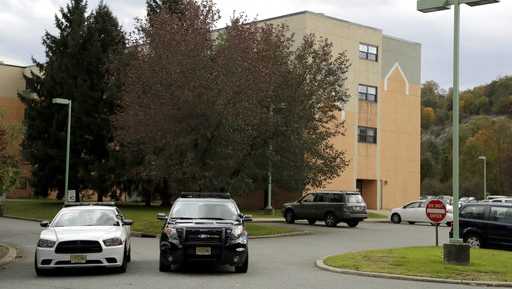 Police cruisers are seen parked near the entrance of the Wanaque Center for Nursing and Rehabilitation, where New Jersey Health Department confirmed 18 cases of adenovirus, Tuesday, Oct. 23, 2018, in Haskell, N.J. The outbreak has left nine children dead.