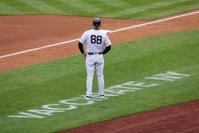 Third&#x20;base&#x20;coach&#x20;Phil&#x20;Nevin&#x20;&#x23;88&#x20;of&#x20;the&#x20;New&#x20;York&#x20;Yankees&#x20;stands&#x20;near&#x20;the&#x20;coaching&#x20;box&#x20;as&#x20;Vaccinate&#x20;NY&#x20;is&#x20;painted&#x20;on&#x20;the&#x20;field&#x20;during&#x20;a&#x20;game&#x20;against&#x20;the&#x20;Washington&#x20;Nationals&#x20;at&#x20;Yankee&#x20;Stadium&#x20;on&#x20;May&#x20;8,&#x20;2021&#x20;in&#x20;New&#x20;York&#x20;City.