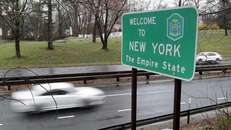 A sign welcomes motorists to New York, on the border with Connecticut, near Rye Brook, N.Y., Sunday, March 29, 2020. On Saturday, after saying he was weighing the idea of a mandatory quarantine for New York, New Jersey and Connecticut, President Donald Trump tweeted that instead he&apos;d issue advisory urging people in those states to avoid any nonessential travel for two weeks. (AP Photo/Seth Wenig)