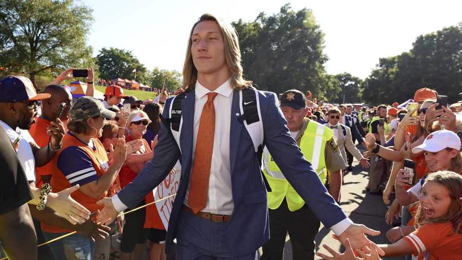 In this Aug. 29, 2019, file photo, Clemson's Trevor Lawrence greets fans as he arrives for the team's NCAA college football game against Georgia Tech in Clemson, S.C. Trevor Lawrence and Zach Wilson are expected to be the top two picks selected in the NFL Draft on Thursday, April 29, 20212, in Cleveland.