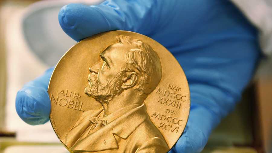FILE- In this file photo dated Friday, April 17, 2015, a national library employee shows the gold Nobel Prize medal.