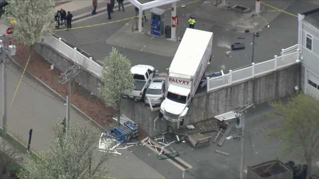 Truck teetering on retaining wall after barrelling through Massachusetts gas station - Vimarsana News