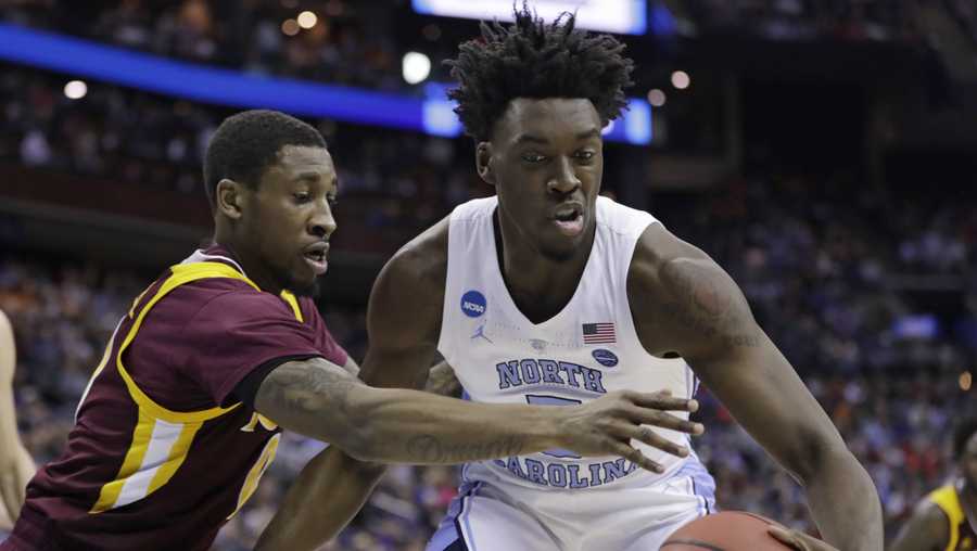 North Carolina's Nassir Little, right, drives past Iona's Rickey McGill in the first half during a first round men's college basketball game in the NCAA Tournament in Columbus, Ohio, Friday, March 22, 2019. 