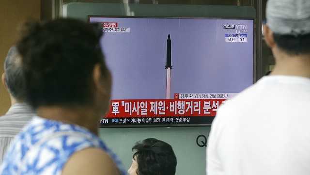 People watch a TV news program showing a file image of a missile being test-launched by North Korea, at the Seoul Railway Station in Seoul, South Korea, Tuesday, July 4, 2017. 