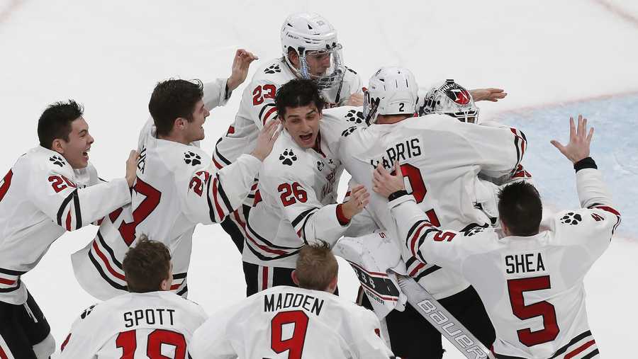 Northeastern players celebrate after defeating Boston University in double overtime during the Beanpot Tournament championship NCAA college hockey game in Boston, Monday, Feb. 10, 2020. (AP Photo/Michael Dwyer)