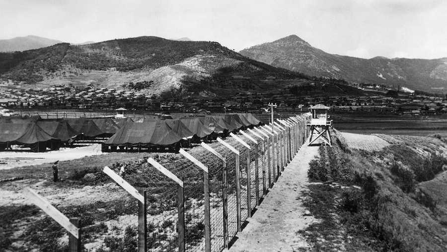 A general view of A P O W camp somewhere in Korea showing fence and guard tower on August 18, 1950. (AP Photo)