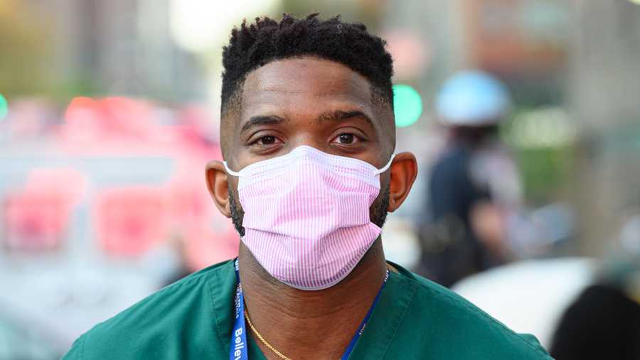 A medical worker poses for a portrait outside NYU Langone Health hospital as people applaud to show their gratitude to medical staff and essential workers during the coronavirus pandemic on May 3, 2020 in New York City. 