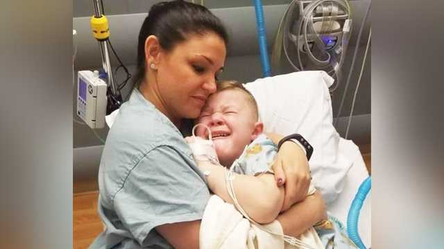 Registered Nurse Annie Hager comforts her 5-year-old patient, Slade Thompson.