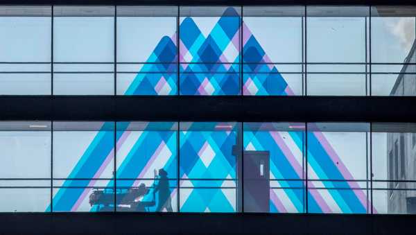 FILE - A medical worker transports a patient at Mount Sinai Hospital, April 1, 2020, in New York.