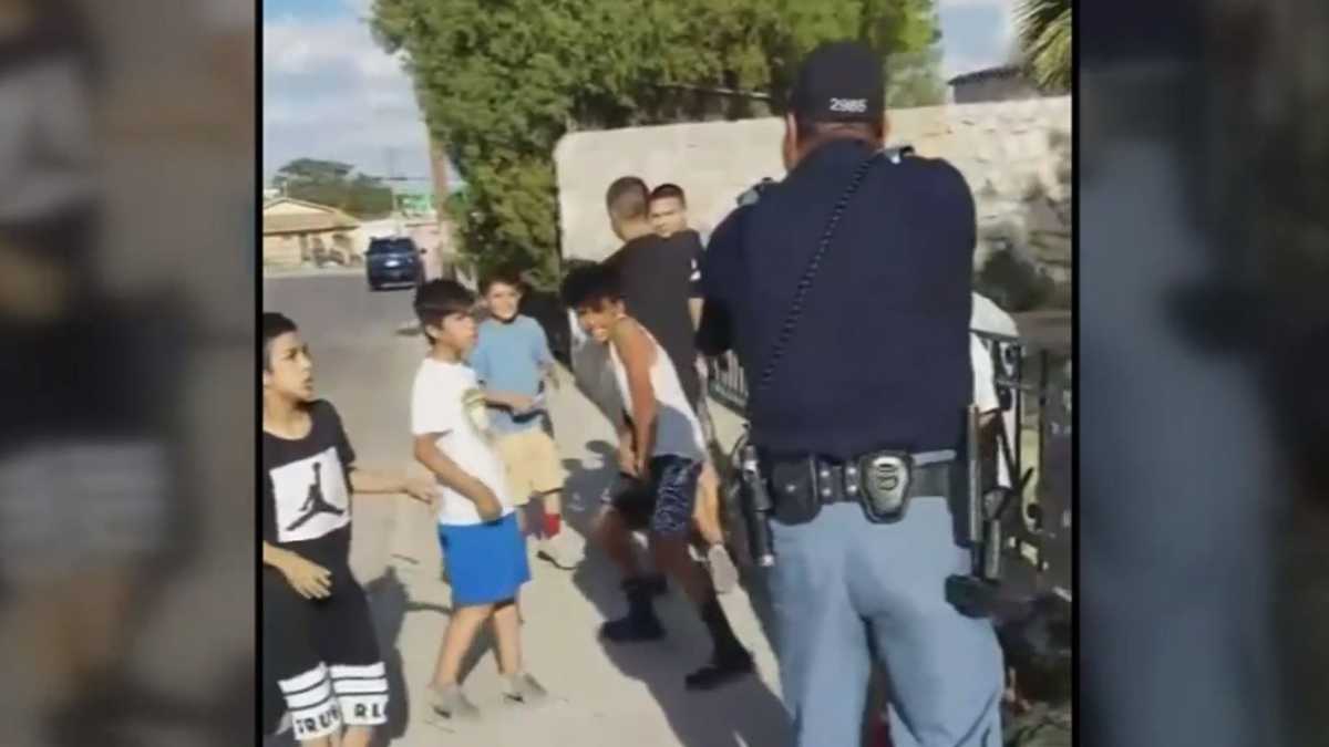 Viral video shows police officer pointing gun at group of children