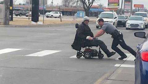 Photos posted by Oklahoma City police show an officer helping a man whose wheelchair lost power.