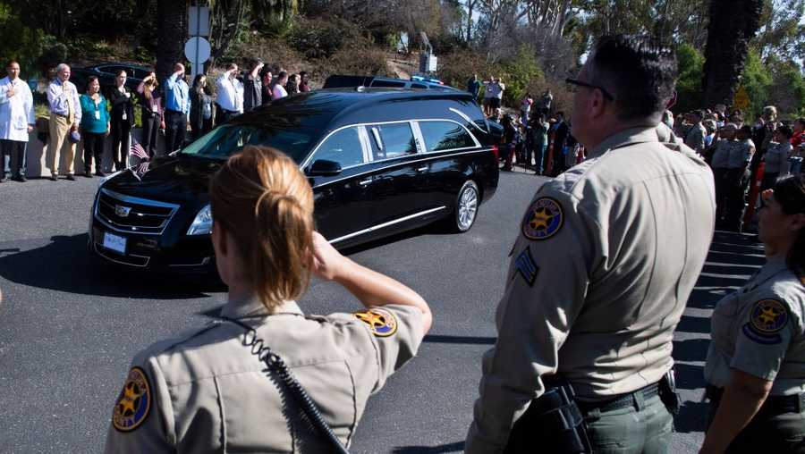 Sheriff's department personnel salute as the body of Ventura County Sheriff Sgt. Ron Helus is brought to the Ventura County Medical Examiner's office on Thursday, November 8, 2018. Helus was shot and killed after entering the scene of a mass shooting during college night at Borderline Bar and Grill in Thousand Oaks, California. 