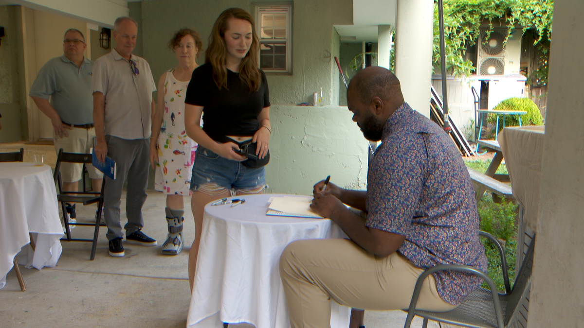 Michael Oher signs When Your Back's Against the Wall