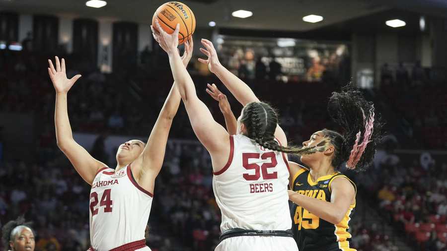 Oklahoma forward Skylar Vann, left, and center Raegan Beers, middle, try to get to a rebound before Iowa forward Hannah Stuelke, right, during the first half in the second round of the NCAA college basketball tournament, Monday, March 24, 2025.