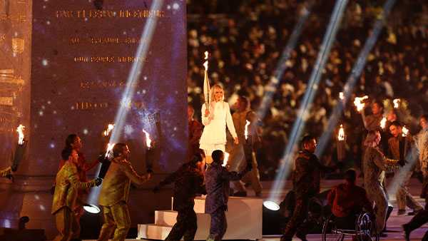 oksana masters, of louisville, carrying the torch at the 2024 paralympics in paris