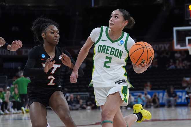 Oregon guard Katie Fiso, right, drives against Virginia Tech guard Leila Wells, left, during the first half in the first round of the NCAA college basketball tournament, Friday, March 20, 2026.
