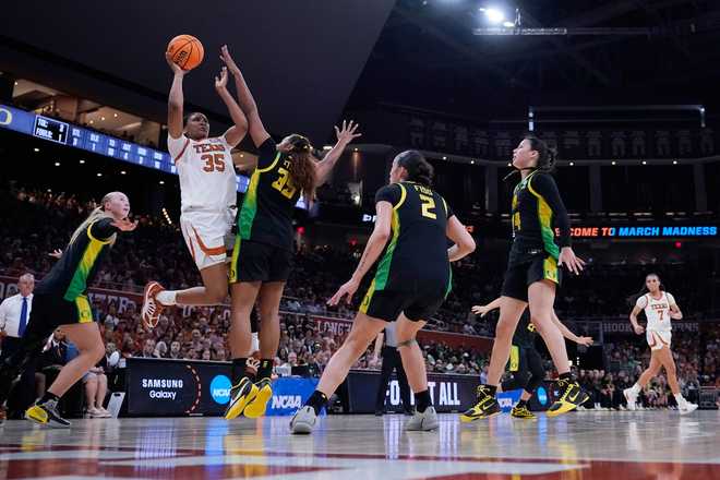 Texas forward Madison Booker (35) drives to the basket against Oregon forward Ehis Etute (35) during the second half in the second round of the NCAA college basketball tournament, Sunday, March 22, 2026.