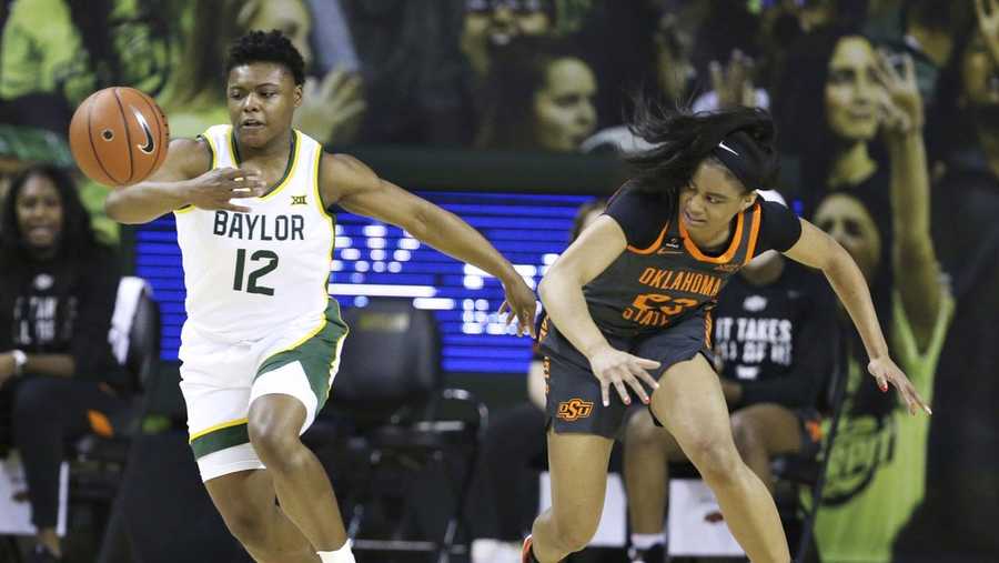 Baylor guard Moon Ursin, left, reaches for a loose ball with Oklahoma State guard Lauren Fields, right, in the first half of an NCAA college basketball game, Wednesday, Feb. 24, 2021, in Waco, Texas. (Rod Aydelotte/Waco Tribune Herald via AP)