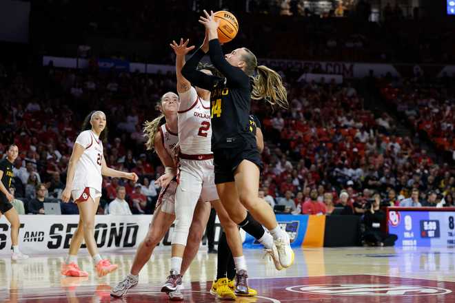 Idaho guard Katlin Kangur (14) goes up to shoot beside Oklahoma guard Aaliyah Chavez (2) during the first half in the first round of the NCAA college basketball tournament, Friday, March 20, 2026, Norman, Okla.