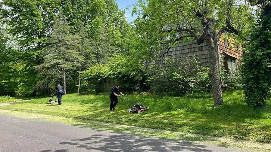 overland park police officers mow overgrown lawn for elderly man who recently lost spouse