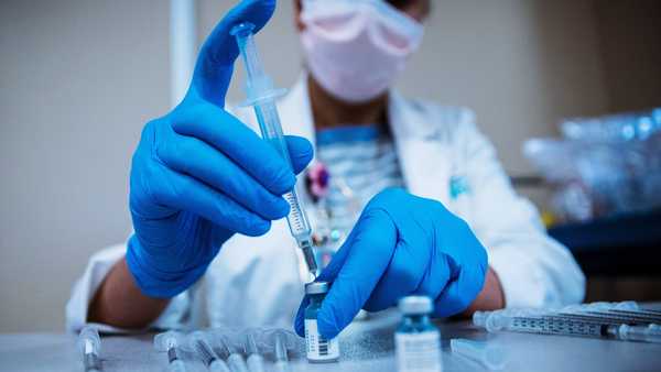 Ann Lee, a pharmacist for Lee Health, prepares COVID-19 vaccines at Gulf Coast Medical Center.
