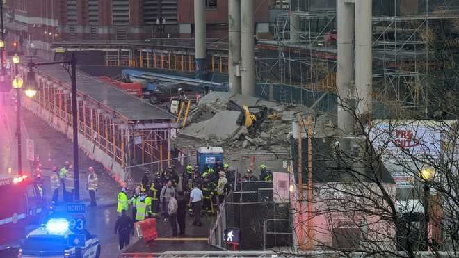 First responders at the scene of a partial building collapse at a parking  x20;garage at 1 Congress St. in the Haymarket area of Boston,  Massachusetts, on March 26, 2022.
