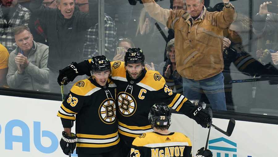 Boston Bruins center Patrice Bergeron (37) is congratulated for his goal during the second period of the team&apos;s NHL hockey game against the Detroit Red Wings, Thursday, Nov. 4, 2021, in Boston. (AP Photo/Charles Krupa)