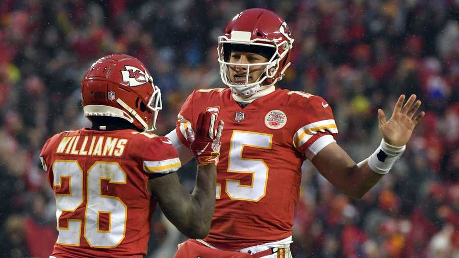 Kansas City Chiefs quarterback Patrick Mahomes (15) celebrates a touchdown with running back Damien Williams (26) during the first half of an NFL divisional football playoff game against the Indianapolis Colts in Kansas City, Mo., Saturday, Jan. 12, 2019. 