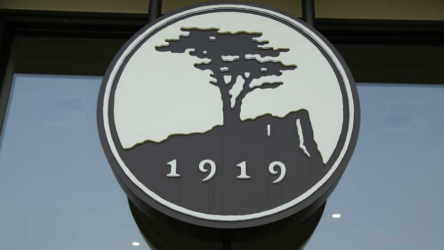 In this photo taken Nov. 8, 2018, is the logo of the Pebble Beach Company outside the new visitors center in Pebble Beach, Calif. The course, which opened in 1919, will be hosting the U.S. Open golf championship in June of 2019. (AP Photo/Eric Risberg)