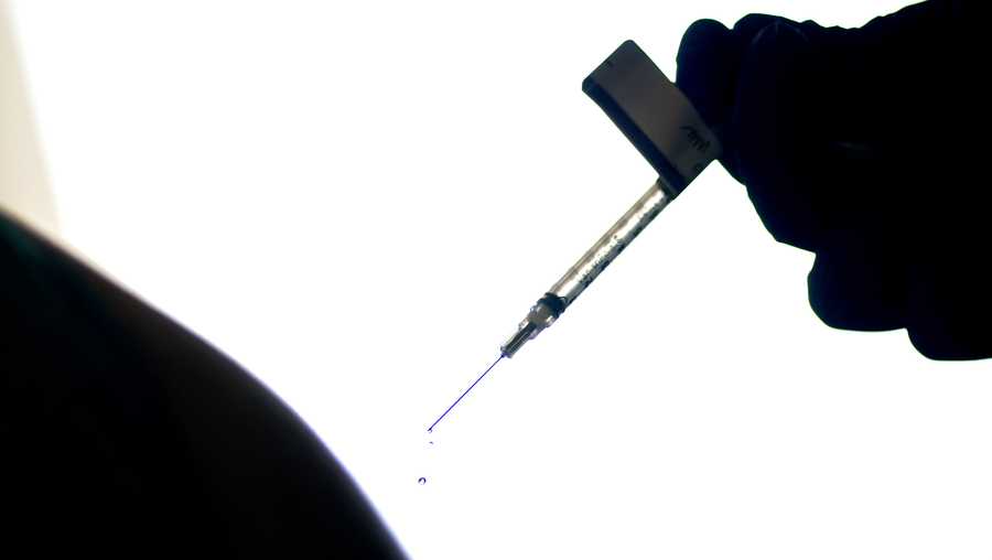 FILE - In this Dec. 15, 2020, file photo, a droplet falls from a syringe after a person was injected with the Pfizer COVID-19 vaccine at a hospital in Providence, R.I.