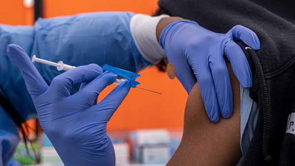 A health care worker administers a Pfizer-BioNTech COVID-19 vaccine to a child at a testing and vaccination site in San Francisco, California, U.S., on Monday, Jan. 10, 2022.