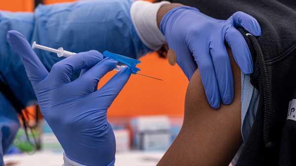 A health care worker administers a Pfizer-BioNTech COVID-19 vaccine to a child at a testing and vaccination site in San Francisco, California, U.S., on Monday, Jan. 10, 2022.